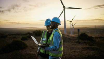 A man and woman at a wind farm